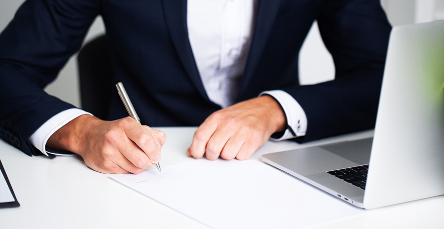 business professional writing at desk