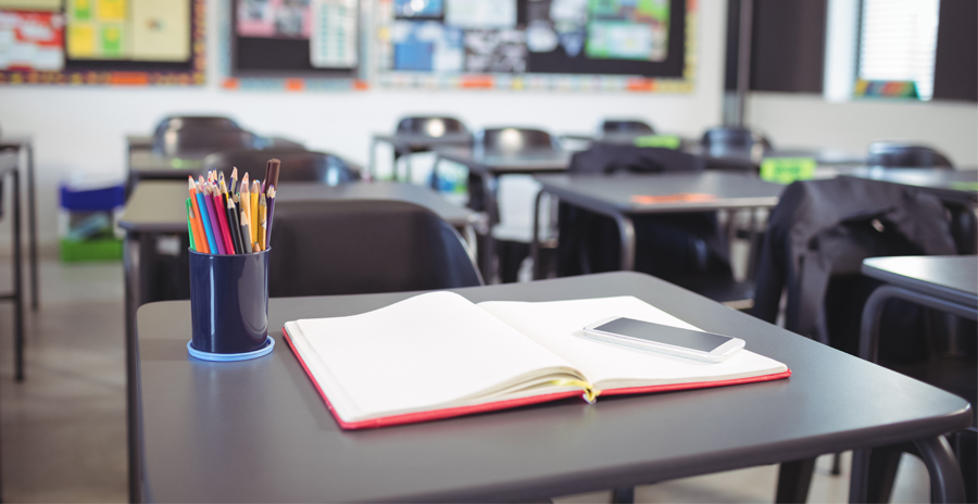 empty school classroom with school supplies